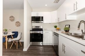 Winnipeg townhouse for rent - A modern kitchen with a dining table and chairs.