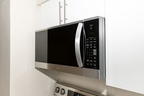 Winnipeg townhouse for rent - A silver microwave oven with a digital display and control panel.