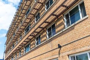 Winnipeg apartment for rent - A red brick building with a balcony on the second floor.