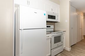 Winnipeg apartment for rent - A white refrigerator and oven in a kitchen.
