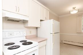 Winnipeg apartment for rent - A white stove and refrigerator in a kitchen.