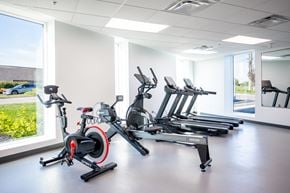 Winnipeg apartment for rent - A gym with a row of stationary bikes.