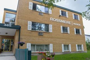 Winnipeg apartment for rent - A brick building with the words Rossmere Manor on the side.