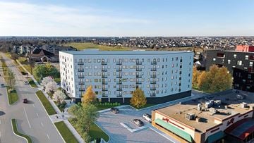 Winnipeg apartment for rent - A modern building with a parking lot in front of it.