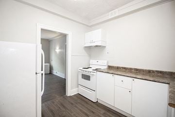 Winnipeg apartment for rent - a white kitchen with white appliances and a white refrigerator