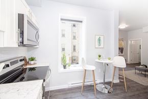 Winnipeg apartment for rent - a kitchen with a small table and two chairs next to a window with a view Winnipeg