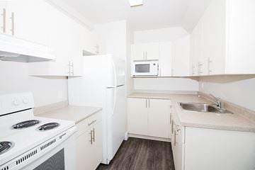 Winnipeg apartment for rent - a white kitchen with white appliances and white cabinets