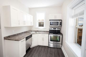 Winnipeg apartment for rent - a kitchen with stainless steel appliances and white cabinets