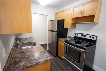 Winnipeg apartment for rent - a kitchen with stainless steel appliances and granite counter tops and