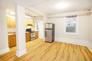 Winnipeg apartment for rent - a kitchen with a stainless steel refrigerator and a window
