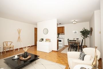 Winnipeg apartment for rent - A modern living room with a black coffee table and a white sofa.