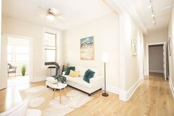 Winnipeg apartment for rent - a living room with a white couch and a wood floor
