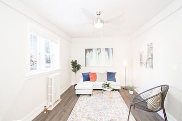 Winnipeg apartment for rent - a living room with a couch and a chair and a ceiling fan