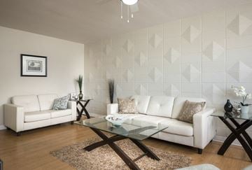 Winnipeg apartment for rent - A living room with a white couch and a glass coffee table.