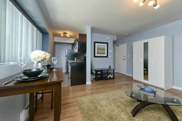 Winnipeg apartment for rent - a living room with a dining room table and a kitchen
