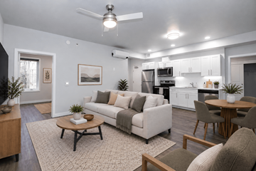 Winnipeg apartment for rent - A modern living room with a white couch and a coffee table.