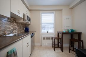 Winnipeg apartment for rent - A kitchen with a table and chairs by a window.