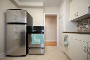 Winnipeg apartment for rent - A kitchen with a stainless steel refrigerator and a black dishwasher.