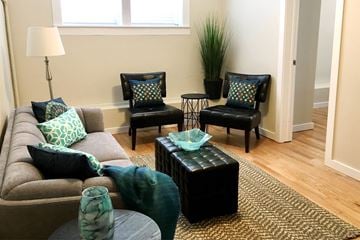 Winnipeg apartment for rent - a living room with a couch and chairs
