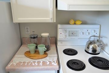 Winnipeg apartment for rent - A kitchen with a white stove top and a white oven.