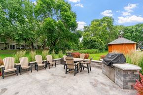 White Bear Lake townhouse for rent - A patio with a table and chairs and a hot tub.