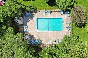 St. Louis Park apartment for rent - An aerial view of a swimming pool surrounded by trees.