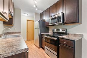 St. Louis Park apartment for rent - a kitchen with stainless steel appliances and wooden cabinets
