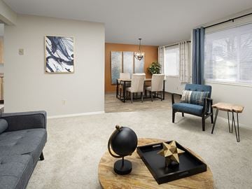 Clackamas apartment for rent - A living room with a grey sofa, a wooden coffee table, and a painting on the wall.