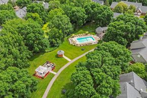 White Bear Lake townhouse for rent - A bird's eye view of a house with a pool surrounded by trees.