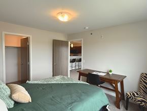 Sioux Falls apartment for rent - A bedroom with a bed, desk, and chair.