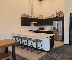 Rapid City apartment for rent - A kitchen with a white countertop and black cabinets.