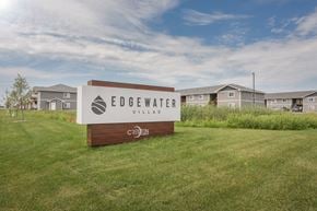 Sioux Falls apartment for rent - the preserve at edgewater village sign in the grass with houses in the background