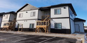Rapid City apartment for rent - A row of houses with a sign that says "For Sale".