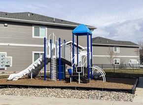 Sioux Falls apartment for rent - A playground with a blue structure and a slide.