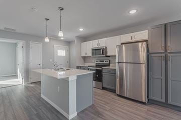 Sioux Falls apartment for rent - a renovated kitchen with stainless steel appliances and a white counter top