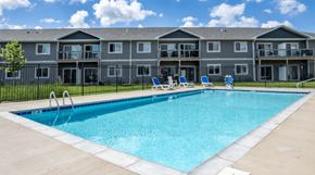 Sioux Falls apartment for rent - A large swimming pool in front of apartment buildings.