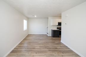 Sioux Falls townhouse for rent - A spacious room with wooden flooring and white walls.