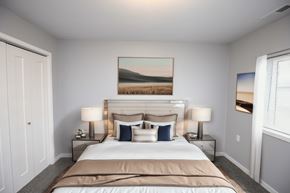 Sioux Falls apartment for rent - A bedroom with a large bed and a painting on the wall.