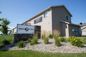 Sioux Falls townhouse for rent - the exterior of a west 23 apartment building with a sign that reads west 23 street