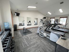 Sioux Falls townhouse for rent - A well-equipped gym with treadmills, weights, and exercise machines.