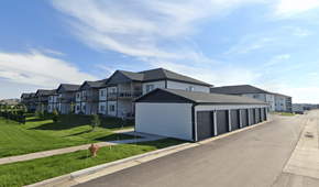 Sioux Falls apartment for rent - A row of houses with a garage in the foreground.