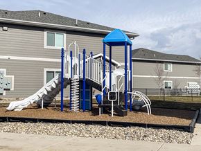Sioux Falls apartment for rent - A playground with a blue structure and a slide.