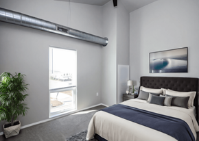 Sioux Falls apartment for rent - A bedroom with a large bed and a painting on the wall.