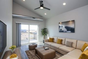 Sioux Falls apartment for rent - A living room with a brown sofa and a ceiling fan.