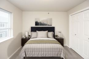 Sioux Falls apartment for rent - A bedroom with a bed, nightstands, and a window.