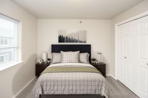 Sioux Falls apartment for rent - A bedroom with a bed, nightstands, and a window.
