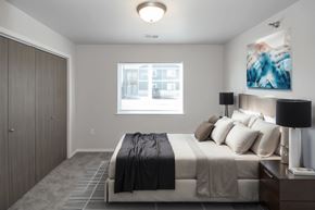 Sioux Falls apartment for rent - A bedroom with a bed, nightstand, and a painting on the wall.