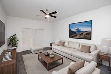 Rapid City apartment for rent - A living room with a large painting of a mountain landscape on the wall.