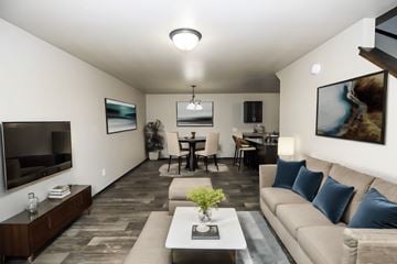 Sioux Falls townhouse for rent - A living room with a couch, a coffee table, and a television.