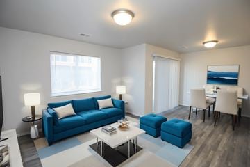 Sioux Falls apartment for rent - A living room with a blue couch and a white coffee table.